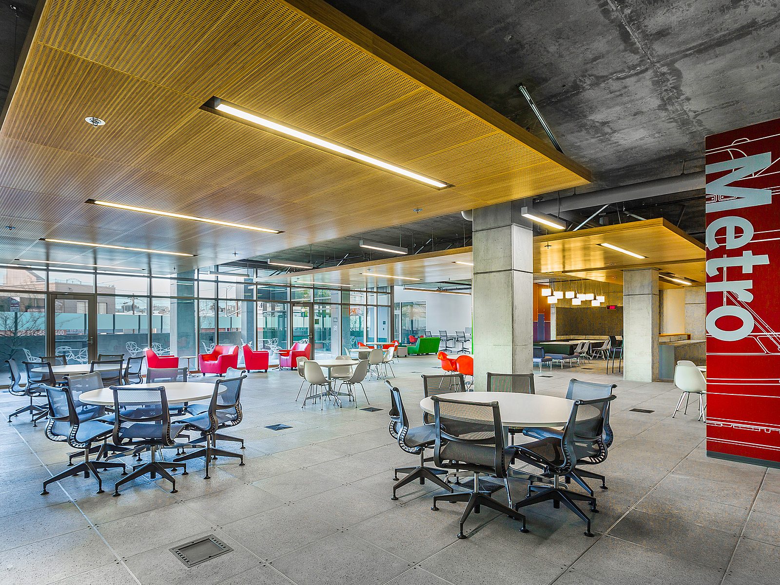 An open office space designed for collaboration, featuring multiple desks and chairs that facilitate group work and foster a productive team environment.