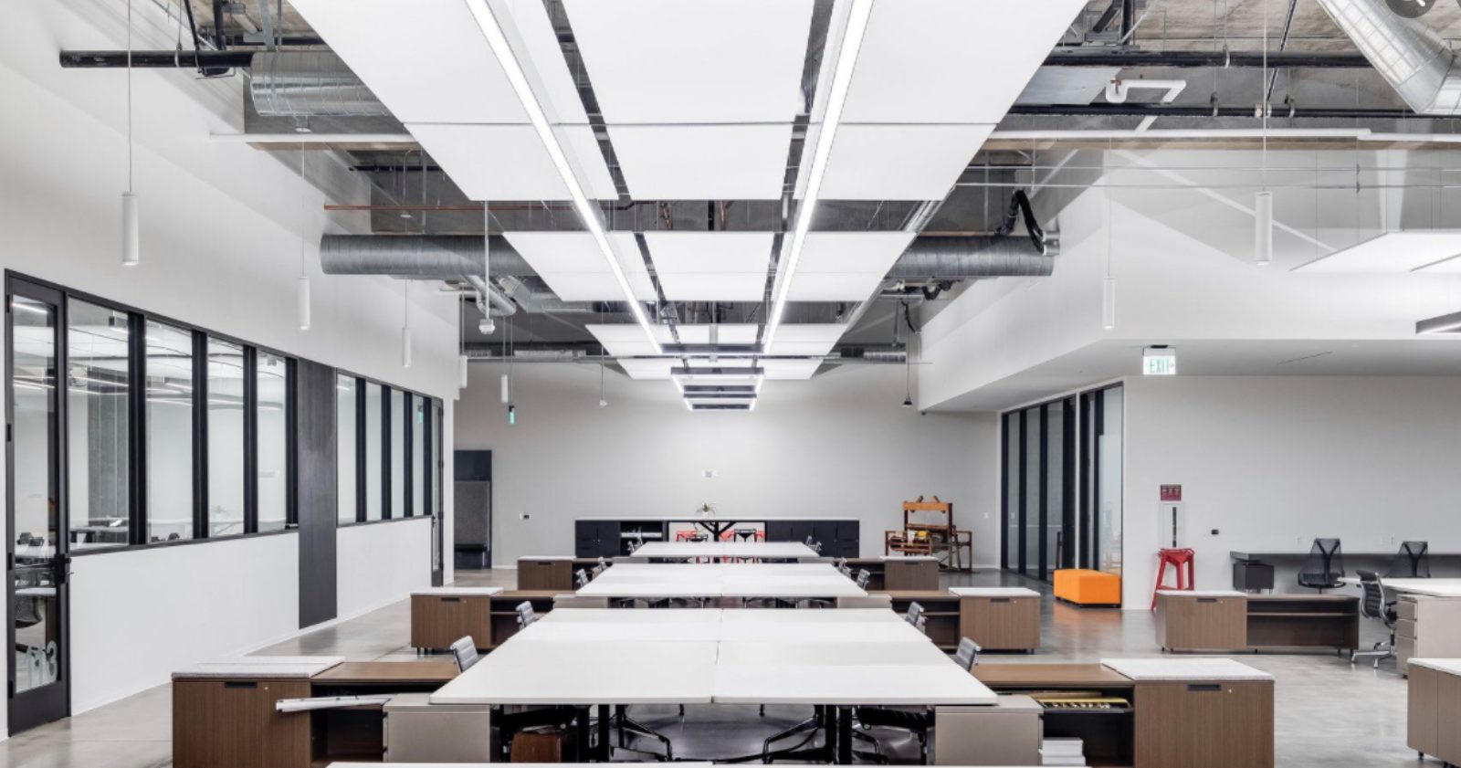 Open office with workstations and adjacent meeting rooms for convenience.