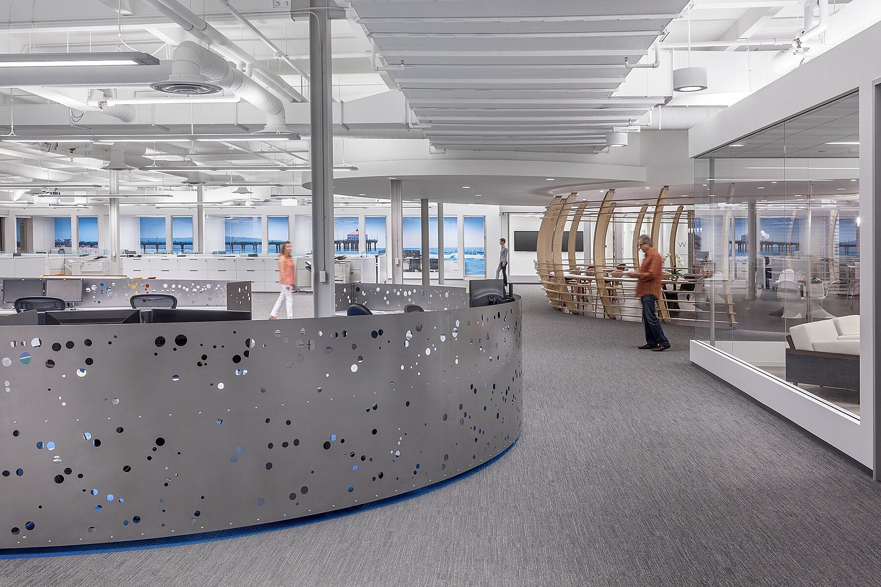 Open office with workstations and silver dividers for privacy.