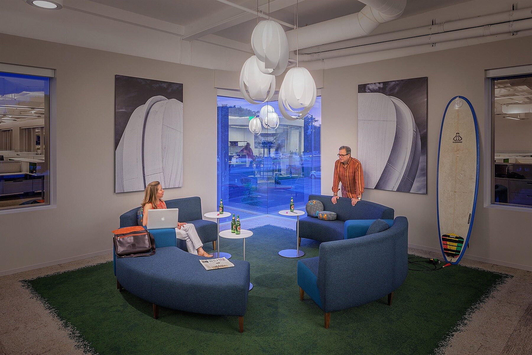 A friendly vibe in the conference room, theres two people talking with each other.