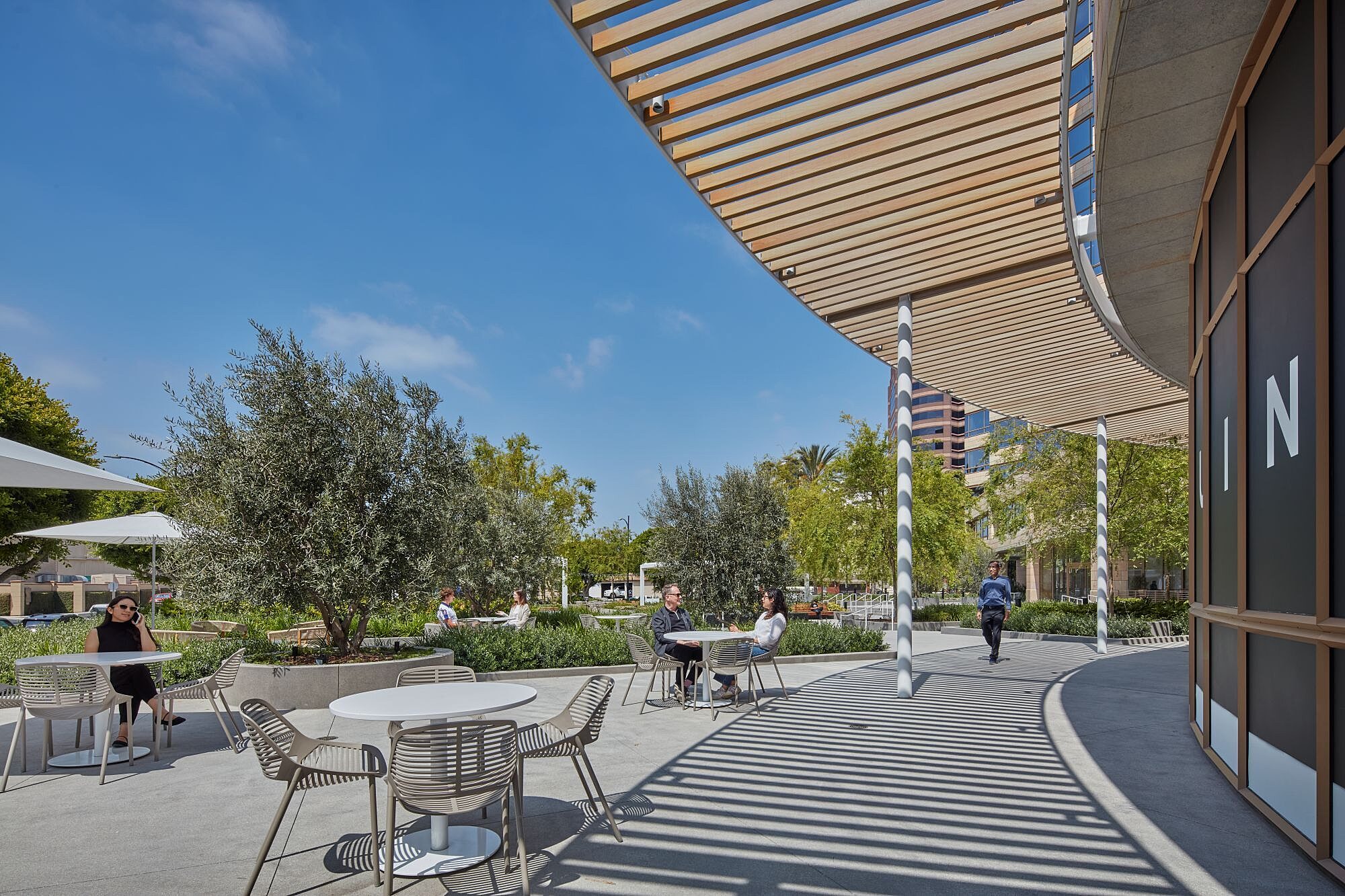 Outdoor collaborative seating and tables at Studio Plaza.