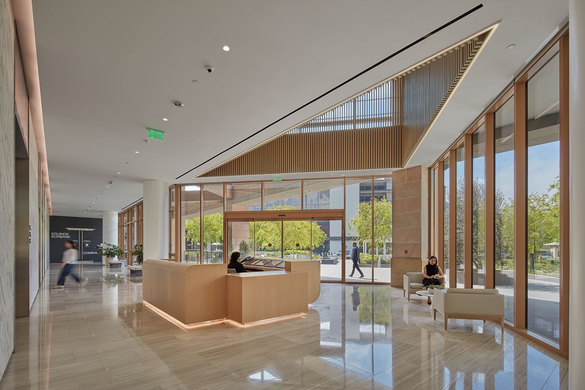 Contemporary reception and seating in a Studio Plaza interior amenity area.