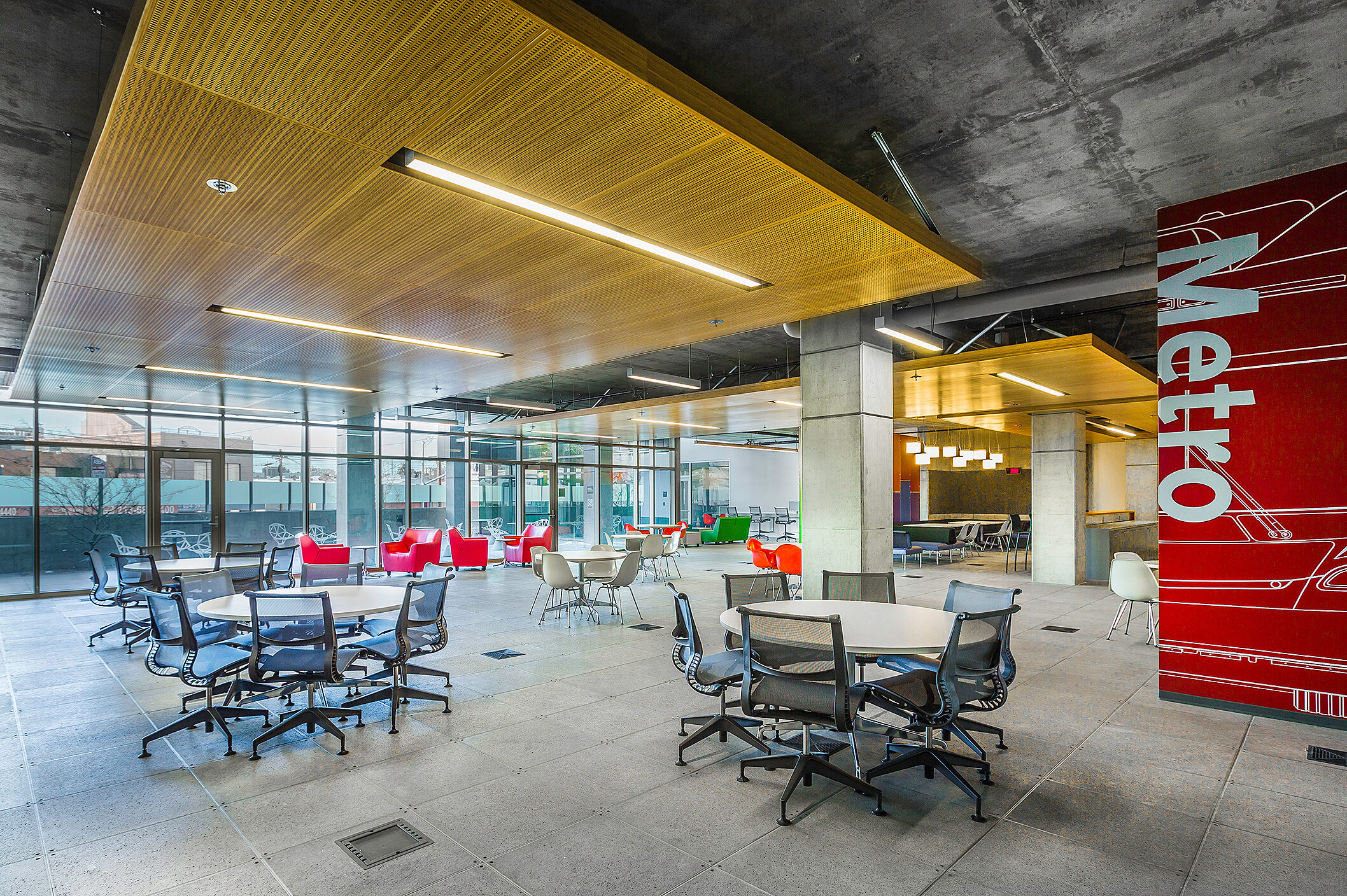 An open office space designed for collaboration, featuring multiple desks and chairs that facilitate group work and foster a productive team environment.