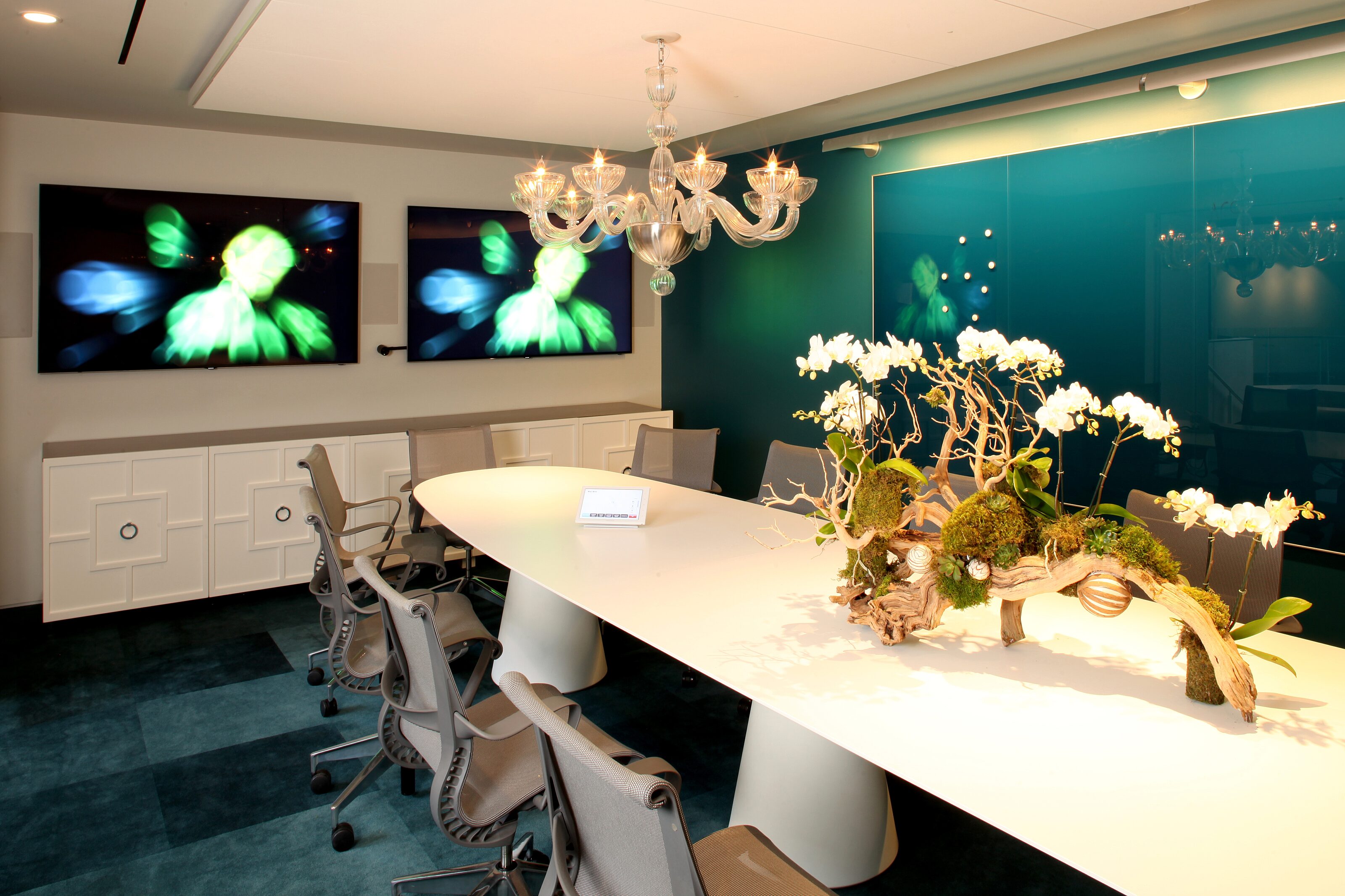 Modern conference room with two huge TV displays for presentations and group discussions.