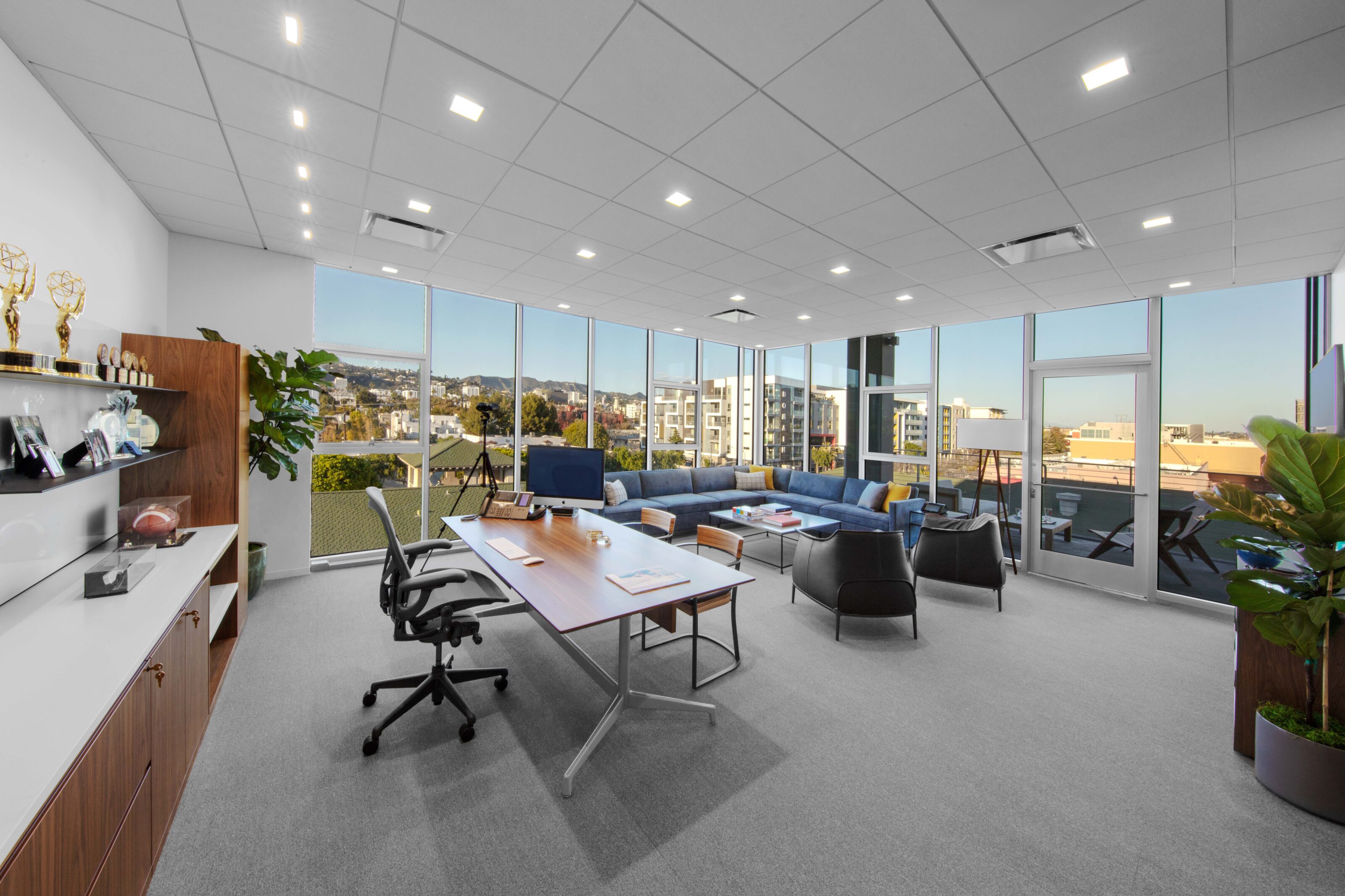 A private office with an ergonomic chair for the occupant and comfortable lounge chairs for guests.