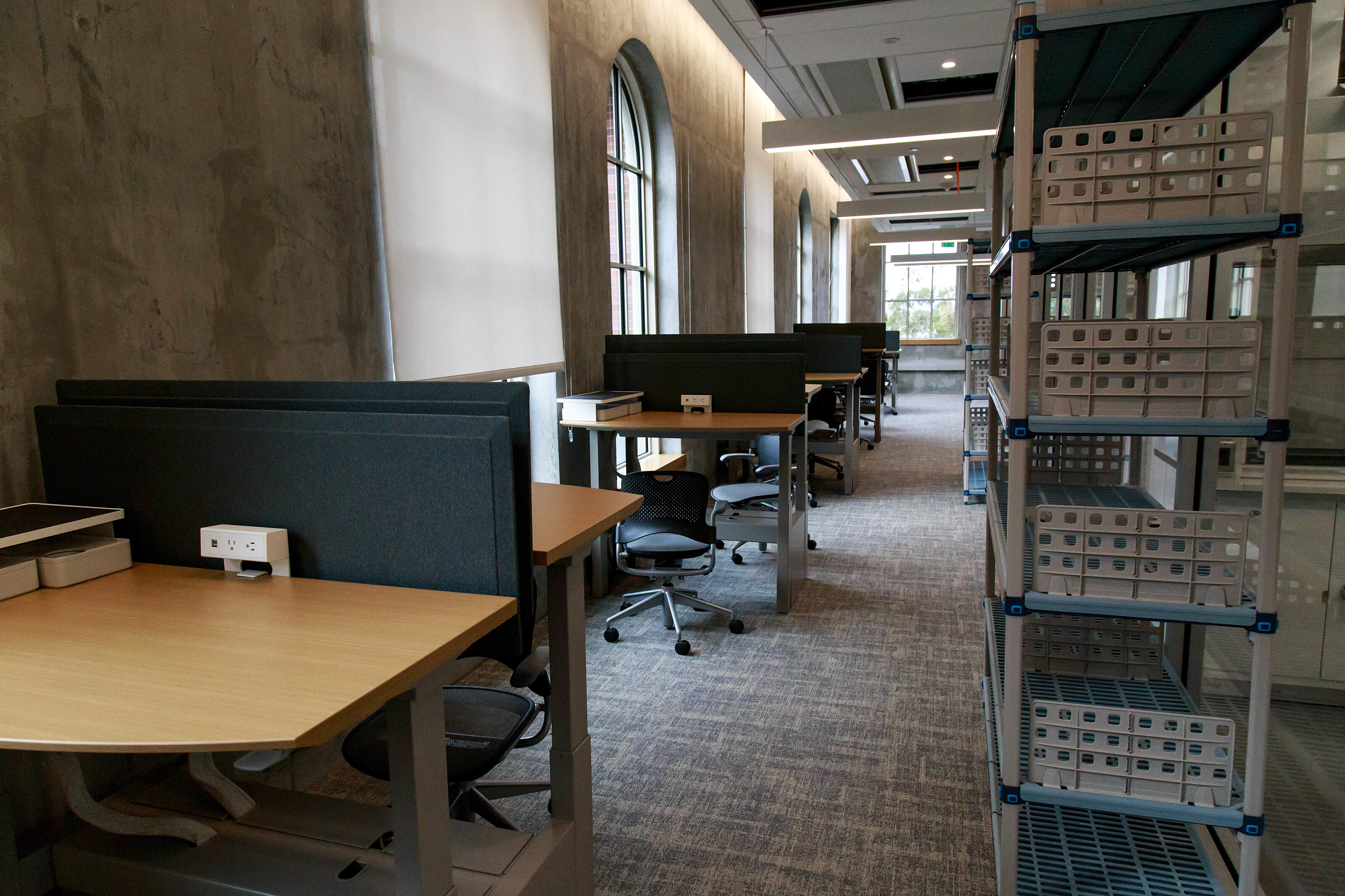 The French window is flanked  beside by a row of workstations.