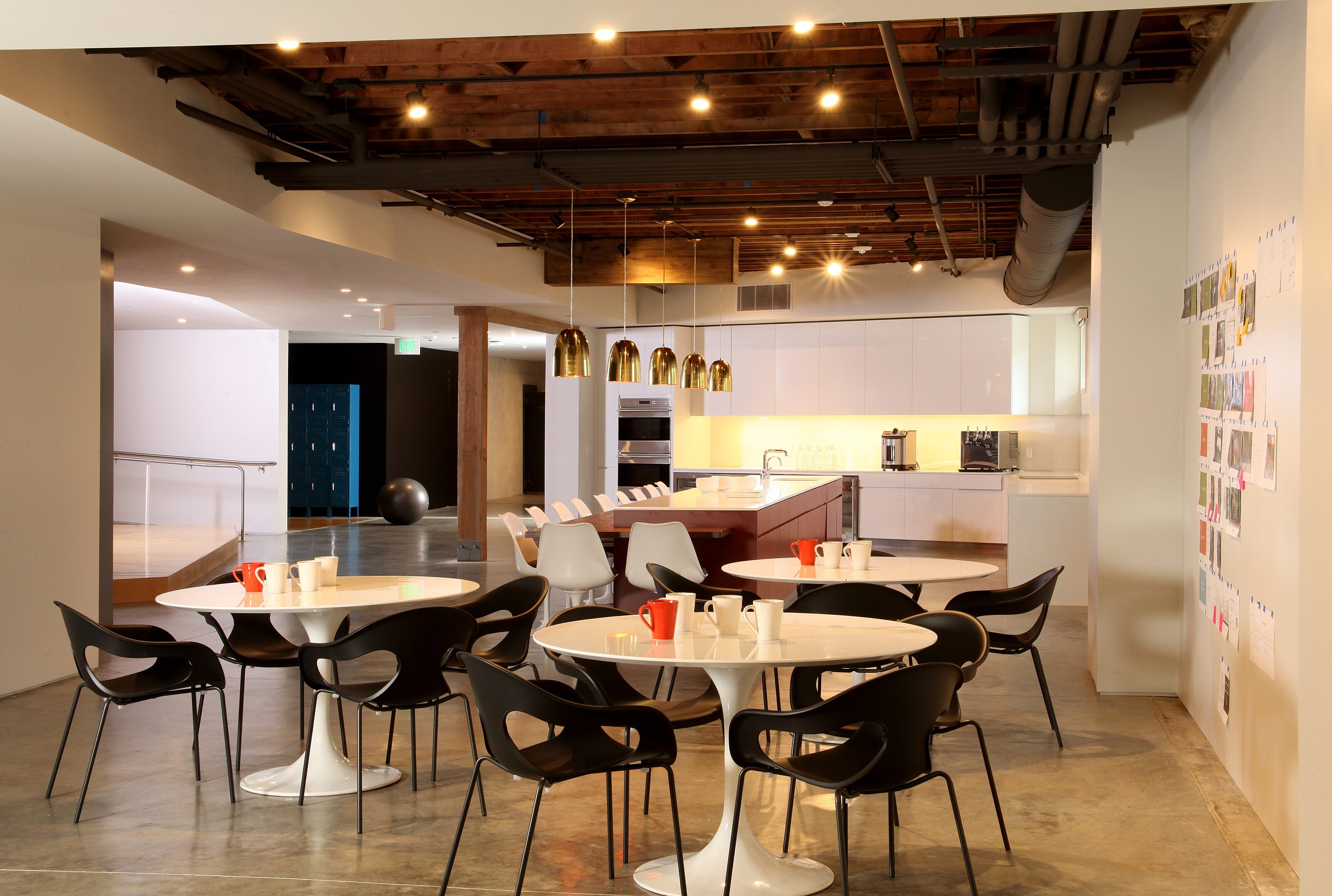 cozy break room featuring a wooden café table and sleek black stools, perfect for a quick recharge or casual conversation.