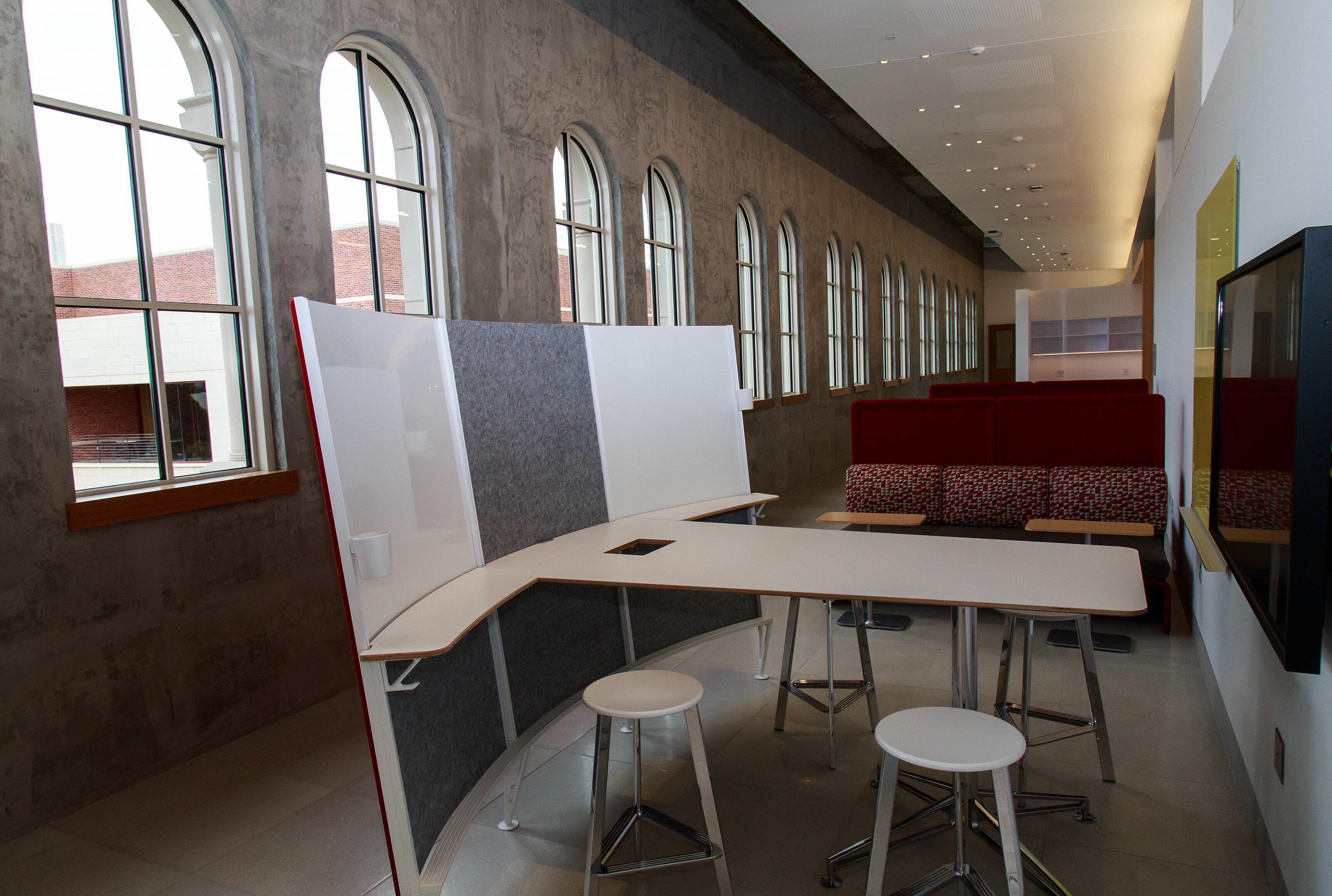 An L-shaped executive desk is located in the hallway, positioned next to a French window.