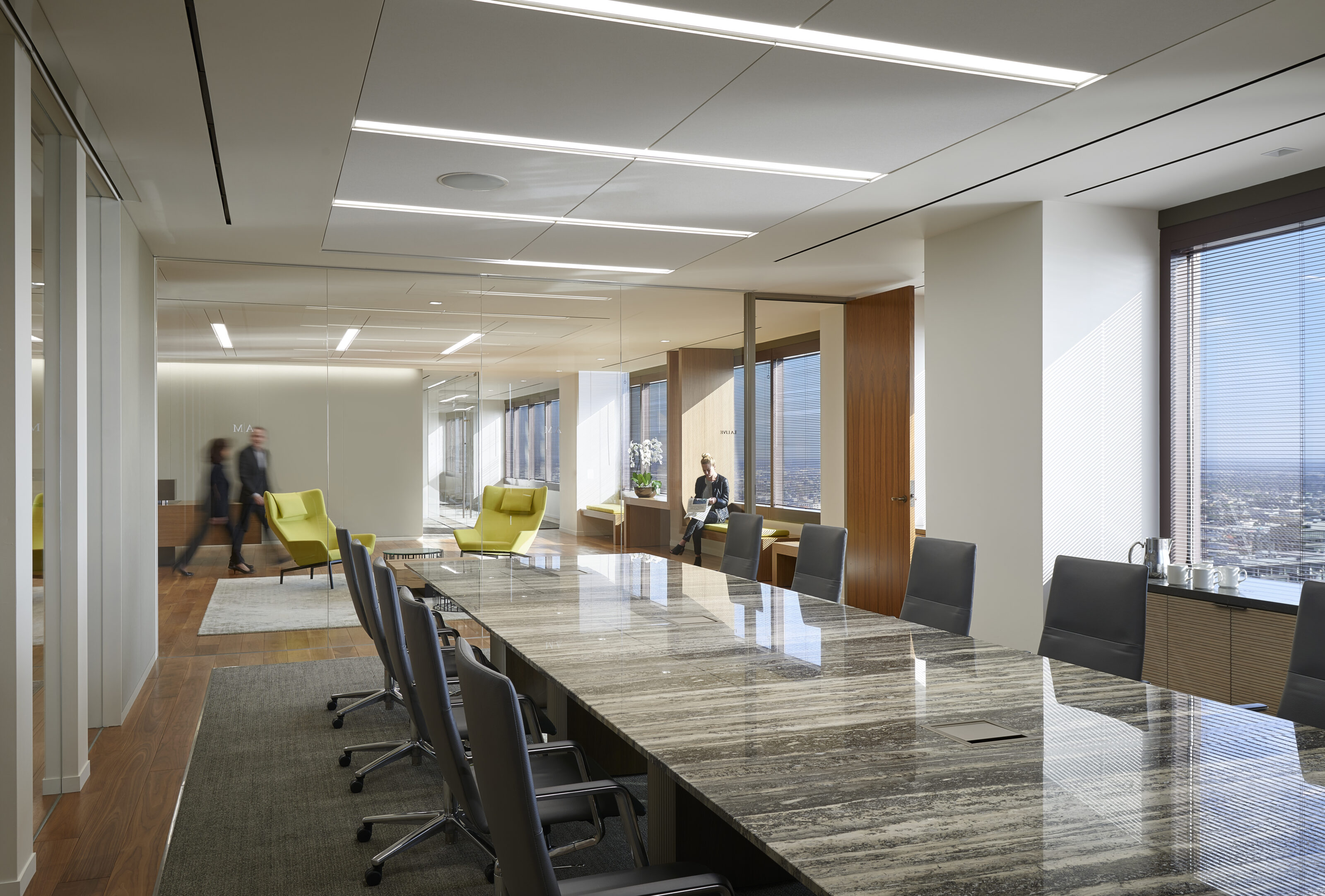 A light luxury meeting room with a marble conference table and office chairs, offering a captivating view from the window.