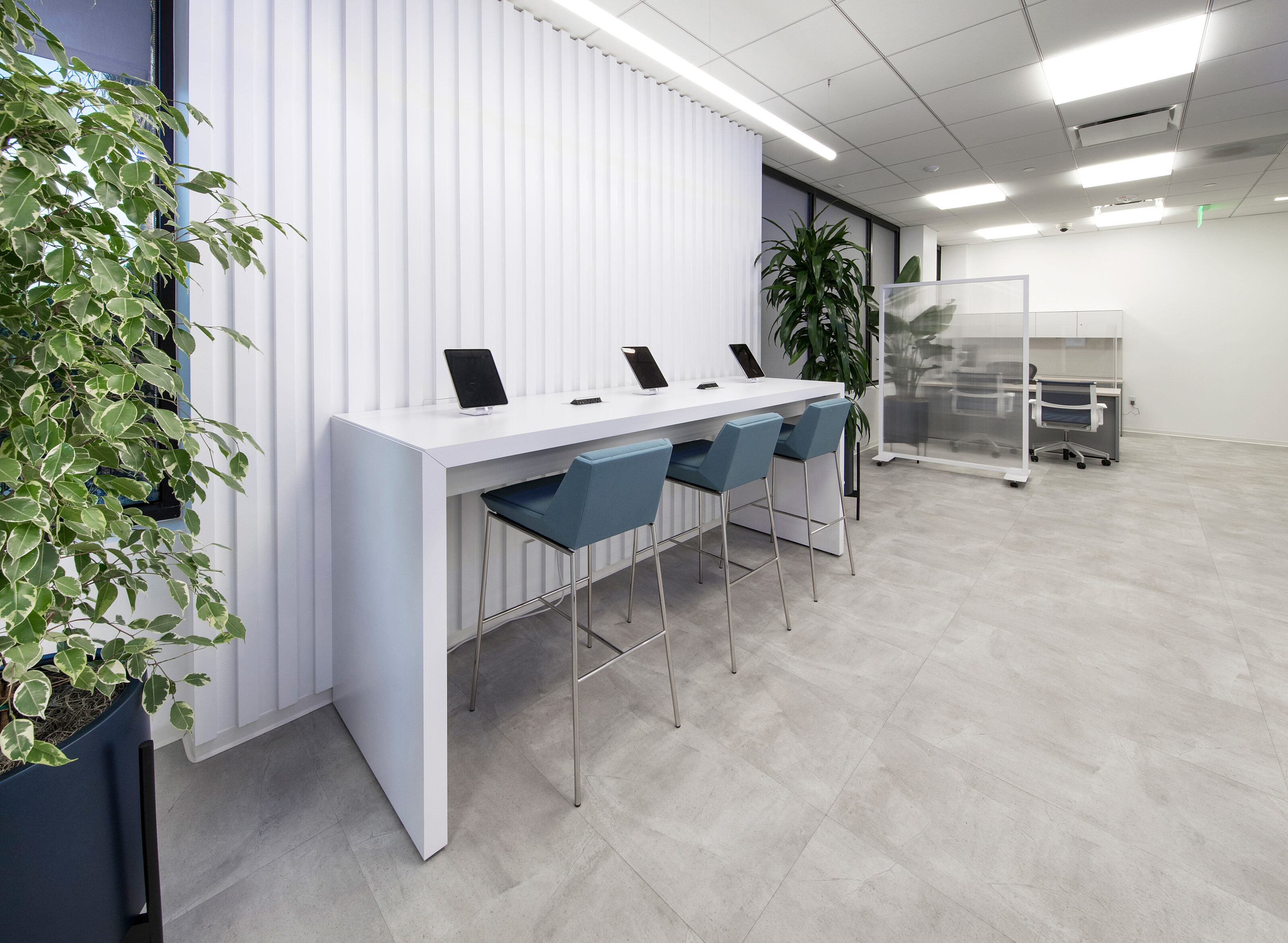 A compact open area with a single tall bar table and a few stools.