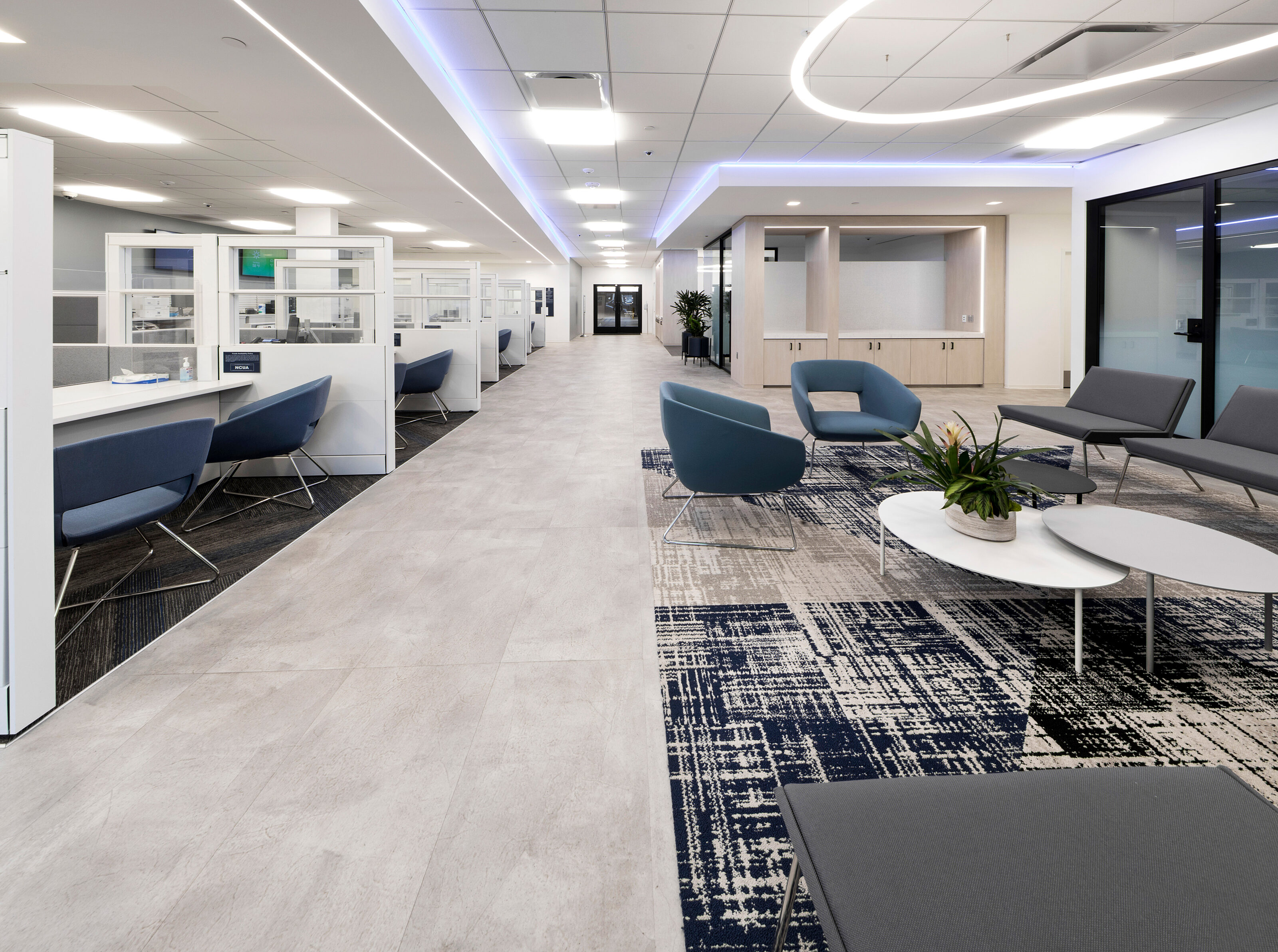 A  open area located next to the service counter, furnished with a pair of chaise lounges and a unique coffee table.