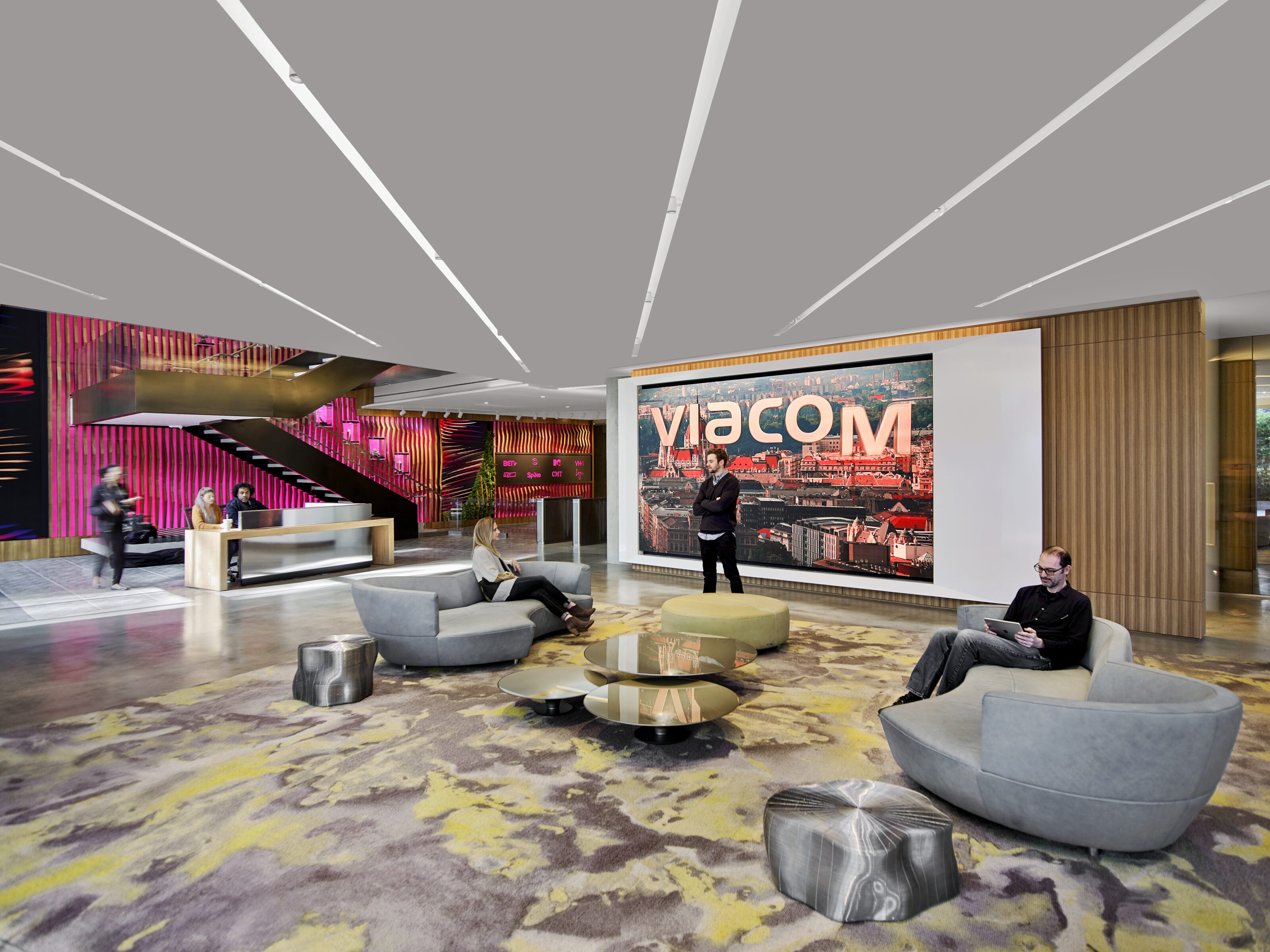 A welcoming lobby featuring cozy gray lounge chairs, providing a comfortable and inviting space for relaxation and unwinding.
