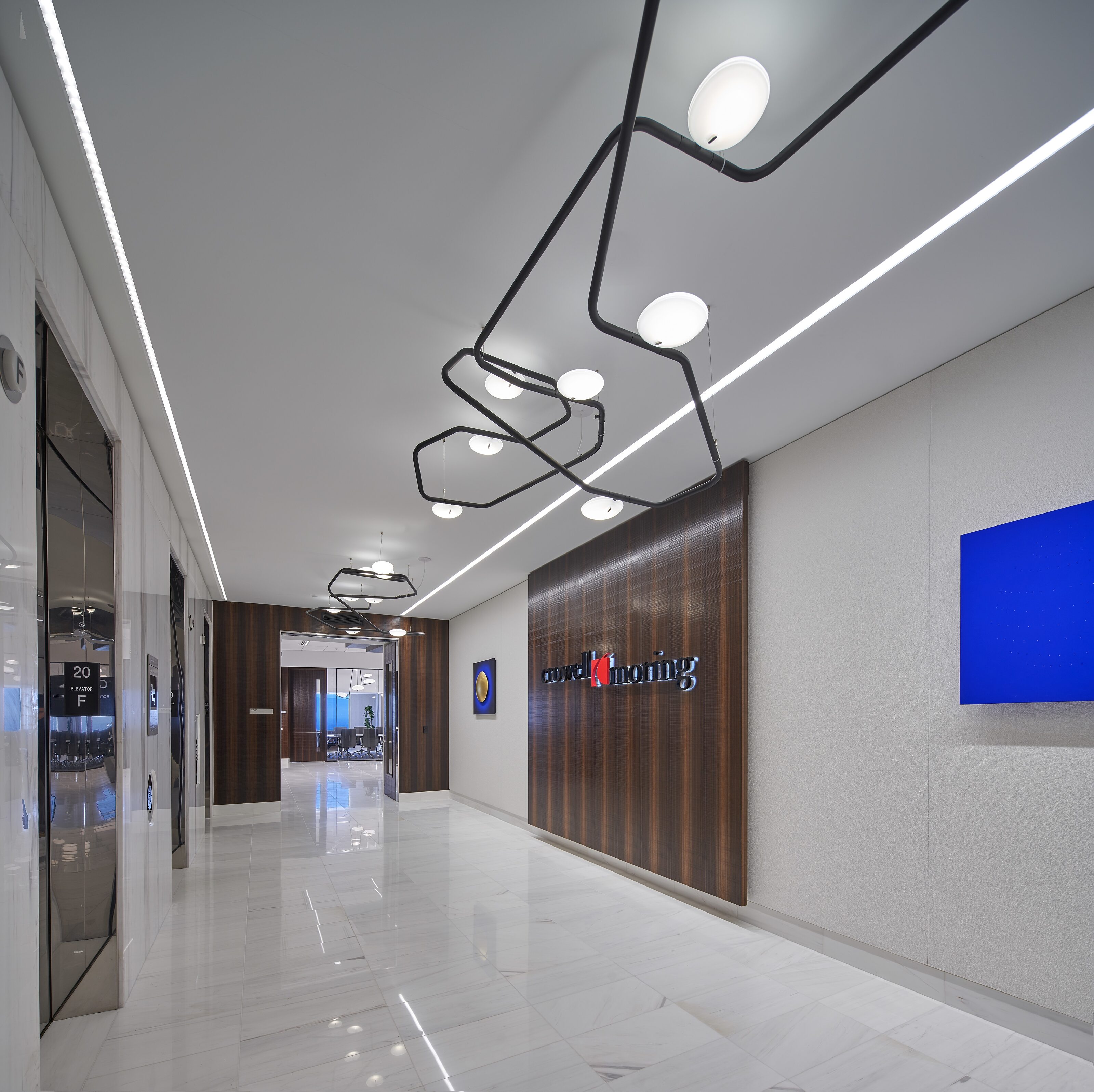 A hall way with company logo name and a television.