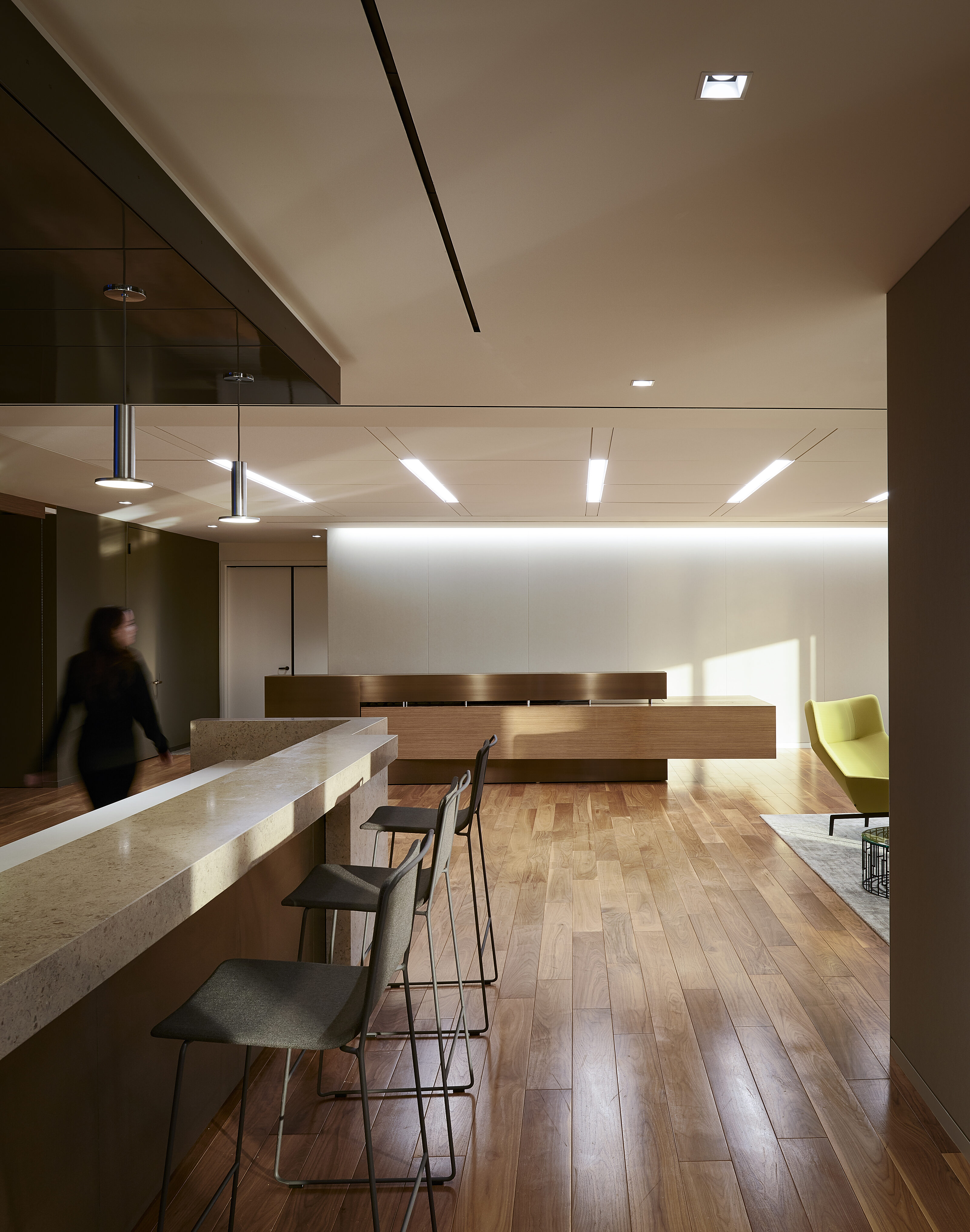 An open breaking area with bar table and stools for seating.
