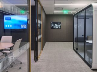 Glass-enclosed meeting rooms in the Paul Hastings Century City office.