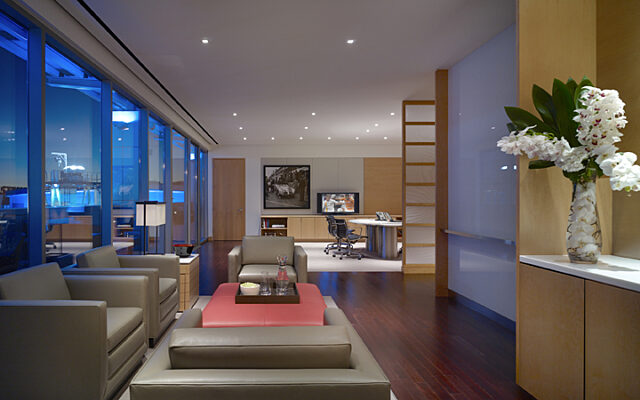 Wooden walls and a coffee table provide a cozy atmosphere in this living room.