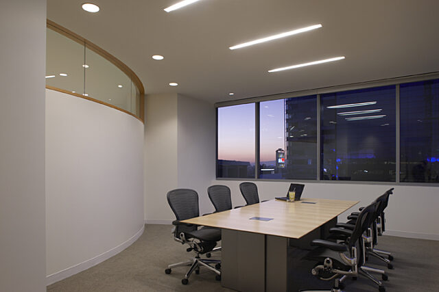 In the private office, office chairs are neatly arranged by the window, offering a tranquil view and a serene workspace for focused productivity.
