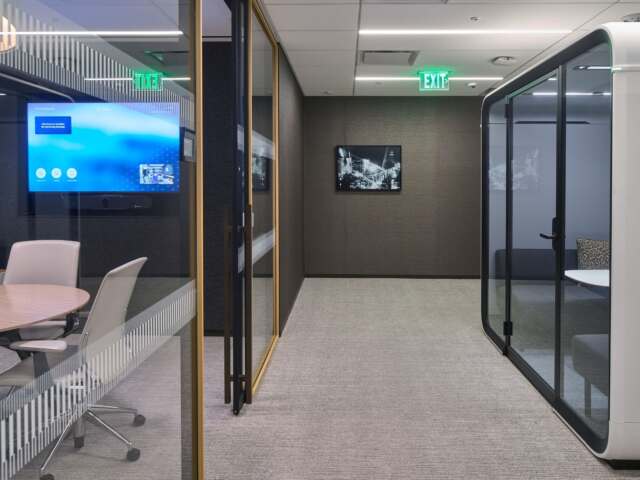 Glass-enclosed meeting rooms in the Paul Hastings Century City office.