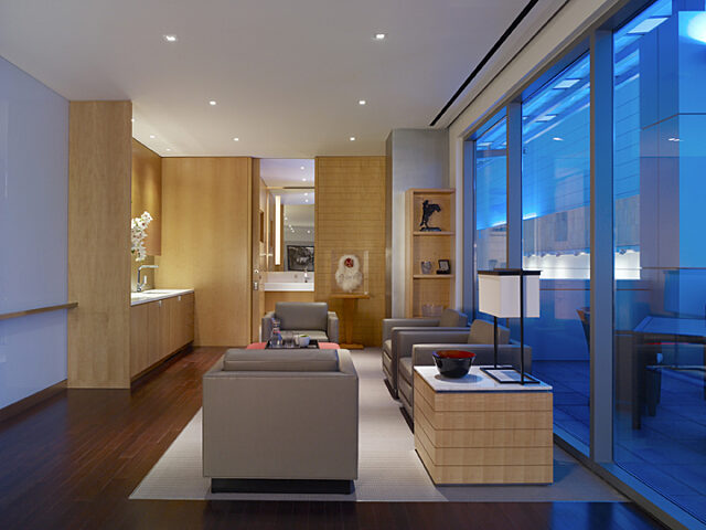 A cozy lounge chair area with a wooden desk positioned conveniently next to it.
