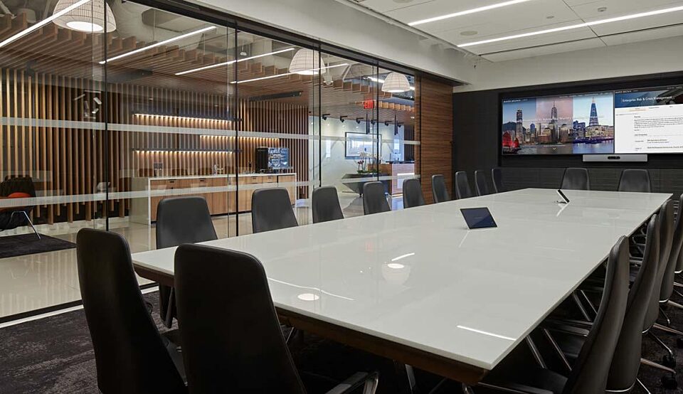 A conference room with a large table and chairs.