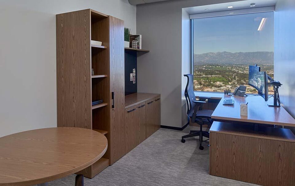 A private office with a height adjustable desk and task chair.
