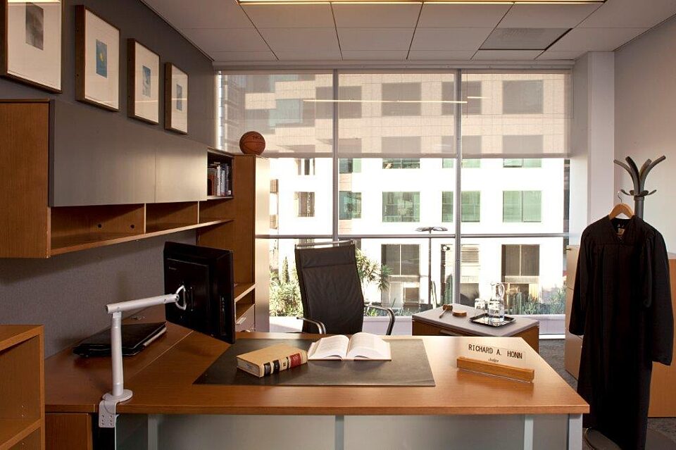 A sleek wooden computer desk and comfortable office chair make this private office great for working. A coat hanger is also available.