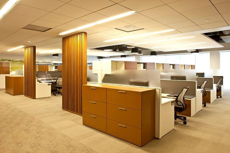 Productive open office with nearby workstations. Each workstation has a computer, storage, desk, and chair for efficiency and collaboration.